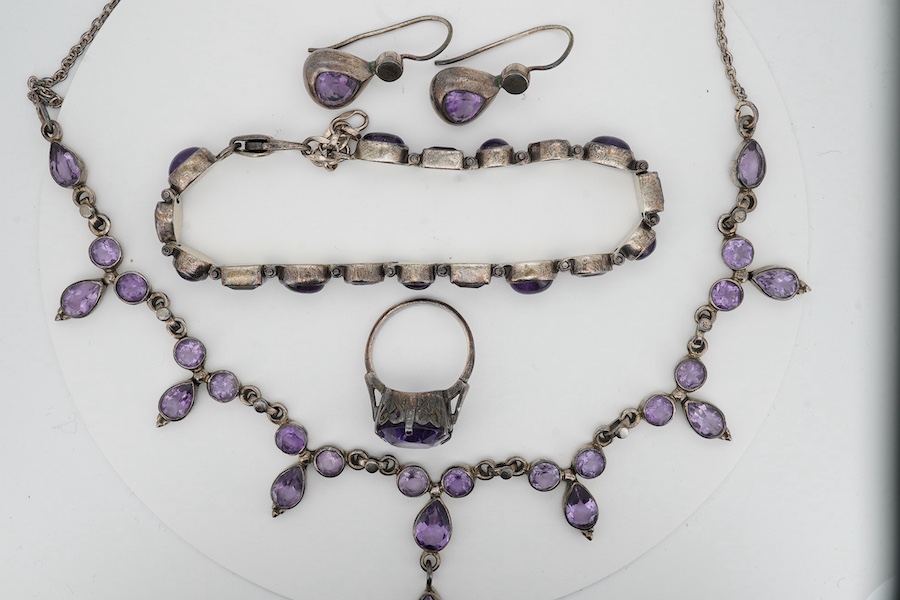 A 925 and amethyst cluster set drop necklace, 44cm, together with a 925 and amethyst set bracelet, a pair of amethyst earrings and a gem set ring. Condition - poor to fair